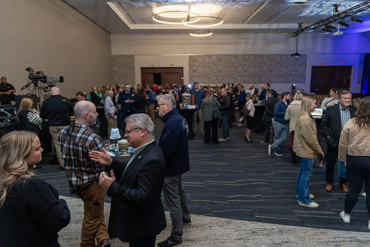 A room full of people visiting at the 2026 Annual Meeting.