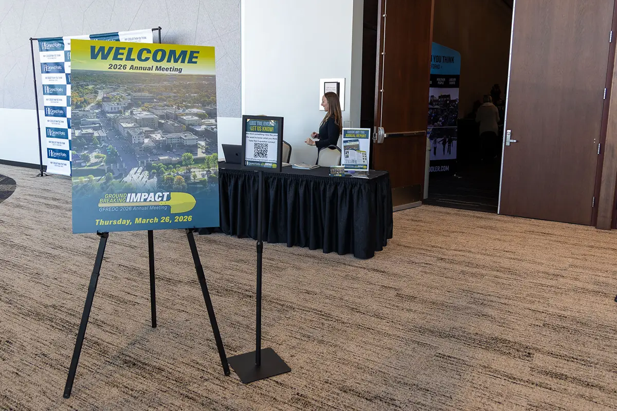 The check-in tables at the 2026 Annual Meeting with the sign.
