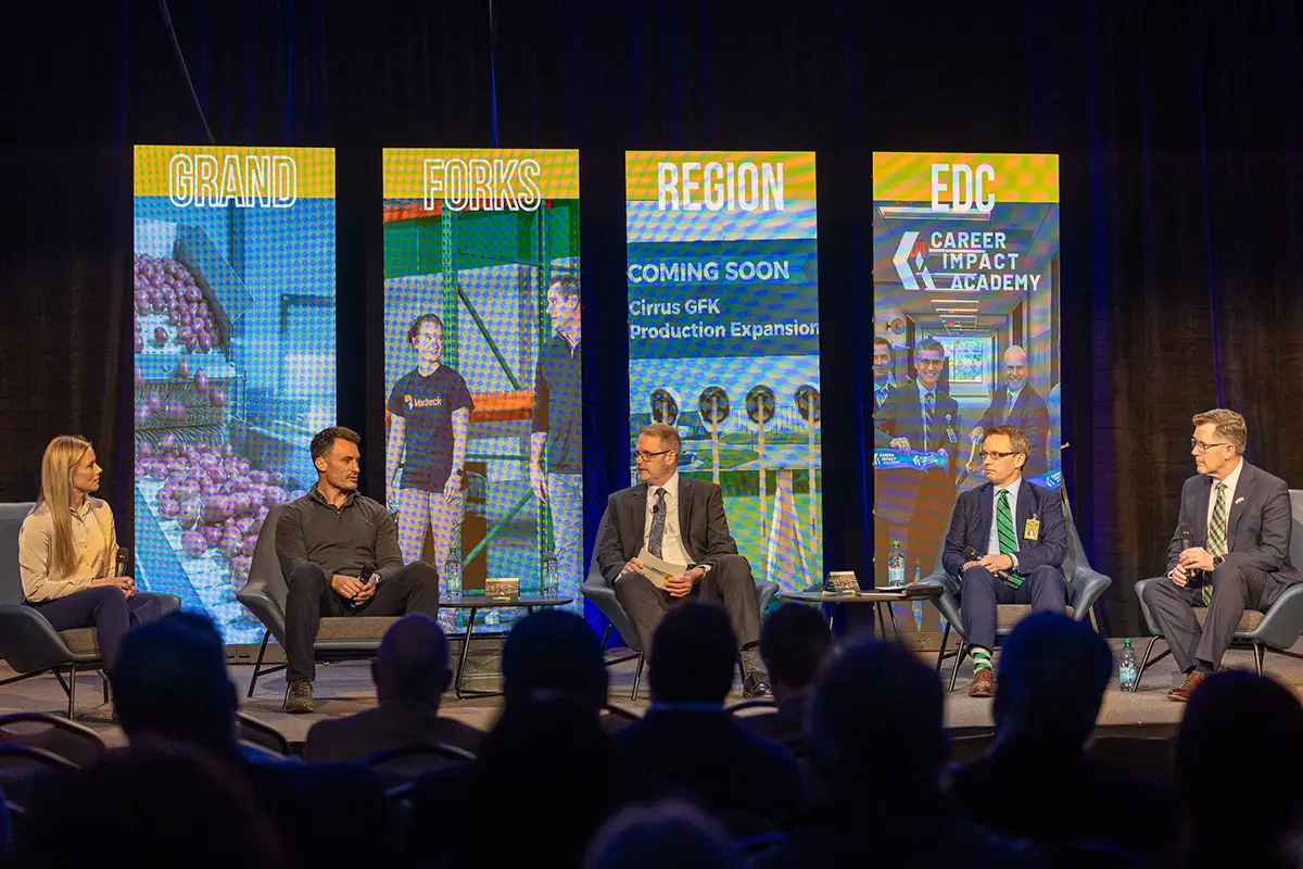 edc president & ceo keith lund sits on stage hosting a panel of grand forks regional leaders.