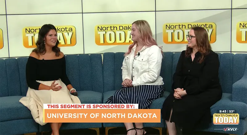 A screenshot from the "North Dakota Today" KVLY TV news segment showing three young women seated on a blue couch during an interview about the InternGF Summer Cohort, with a sponsorship banner reading "This segment is sponsored by: University of North Dakota" at the bottom of the screen.